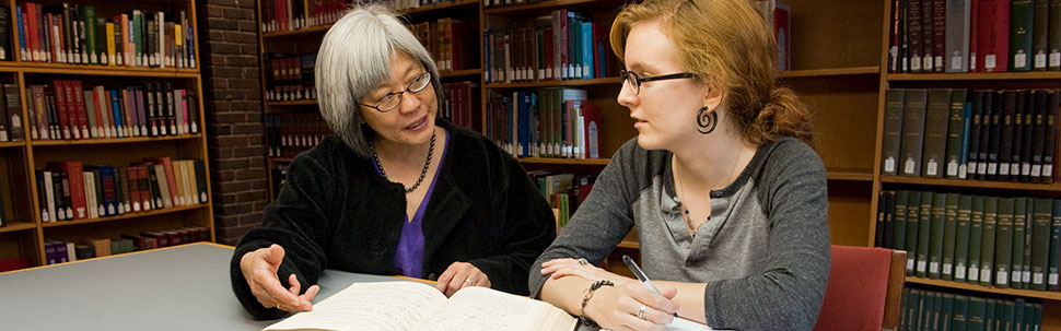 Librarian working with student