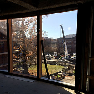 a view of glass installation in the New Neilson Library under construction