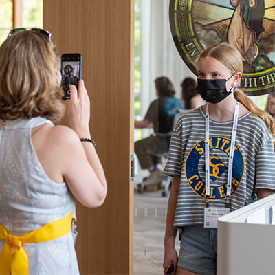 Parent taking photo of student in the libraries