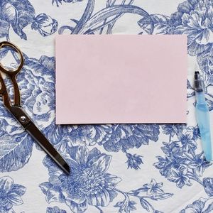 crafting supplies, scissors, on blue floral background