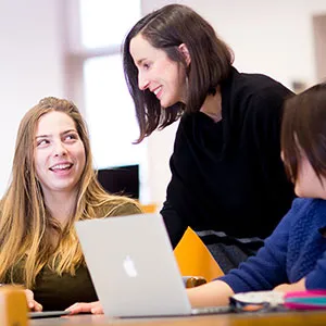 Librarian working with students in Young Library