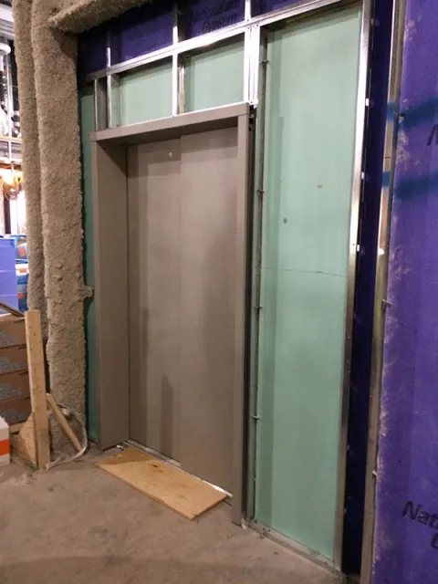elevator behind this door and another 4 elevators being installed in the two buildings