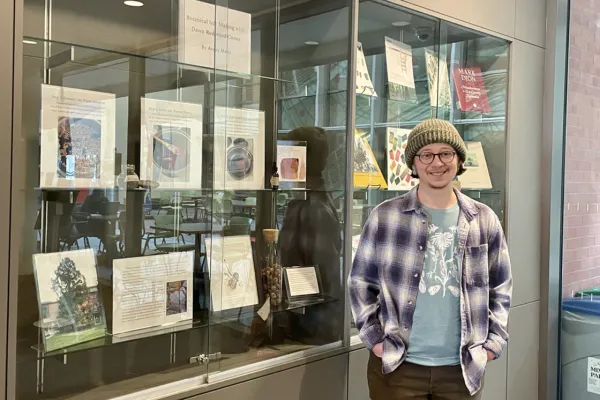Avery Maltz in front of botanical inkmaking display