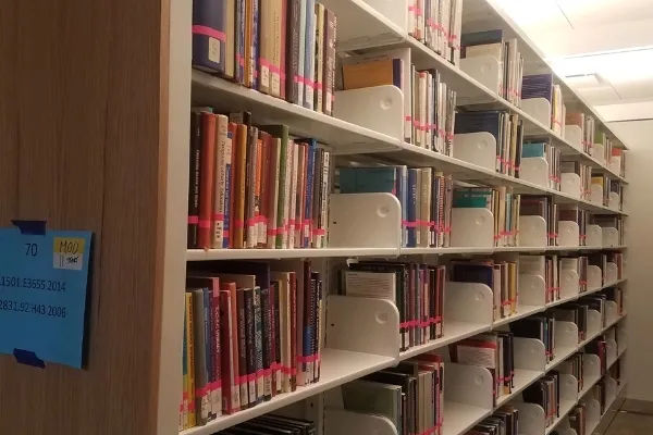 books on metal shelves in the Neilson Library
