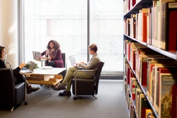 students sitting around a table in a library