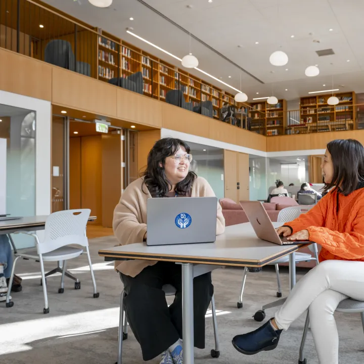 Xochitl Quiroz working with a student in the Learning Commons