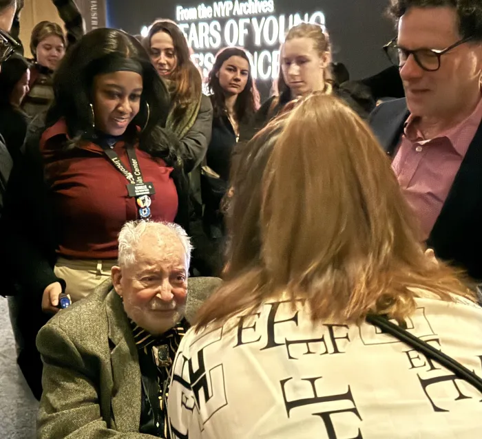 Elim Chan speaks with the father of Jonathan Hirsh, while surrounded by Hirsh and Smith College students