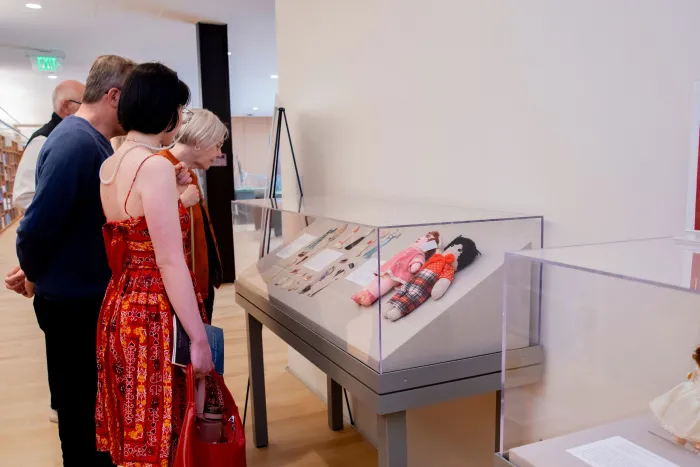 Viewing an exhibition case at Reunion I