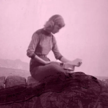 Sylvia Plath sitting on mountain edge