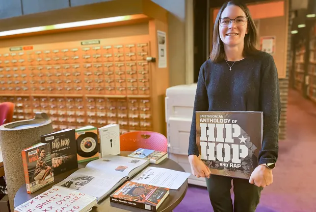 Kat Godfrey with display of Hip Hop materials in Josten Library